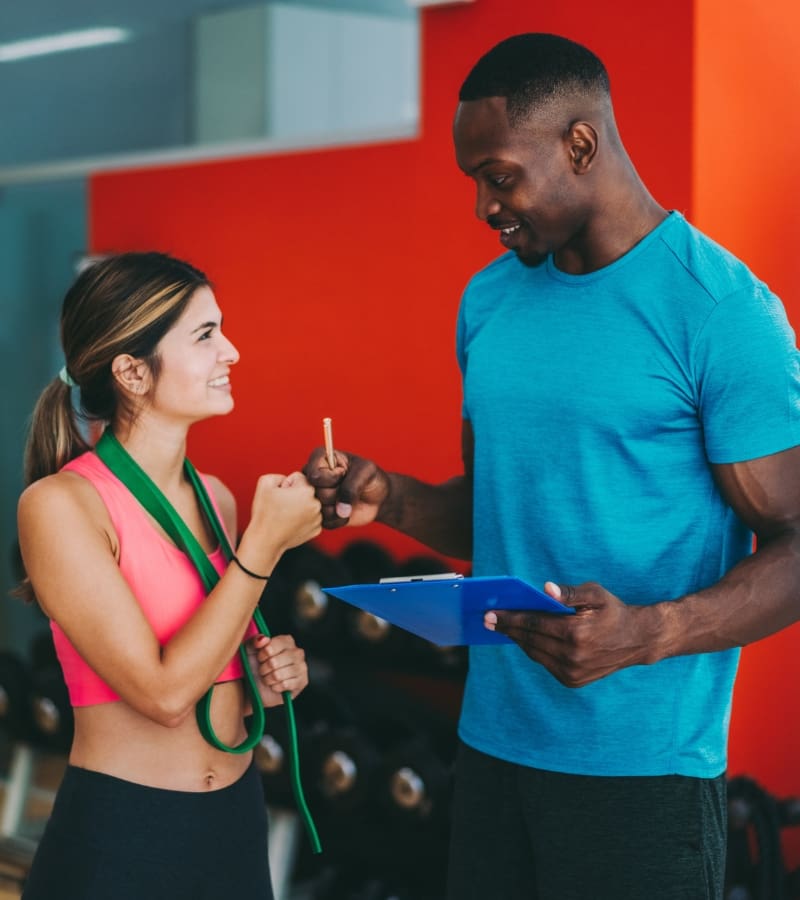 a gym member talks with a personal trainer at a gym near me in reno